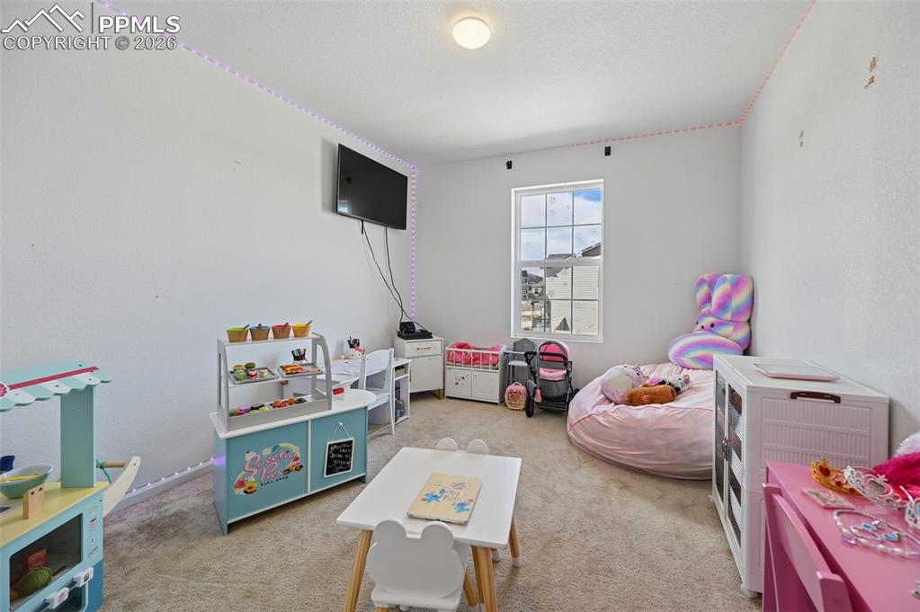 Image 35 of 43: Room featuring a single pane window, mounted television, recessed ceiling l
