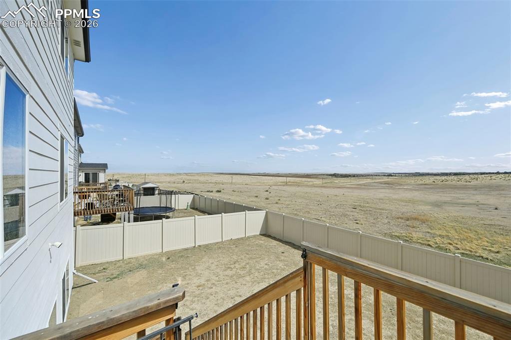 Image 42 of 43: Expansive outdoor space featuring a white privacy fence, multi-level wood d