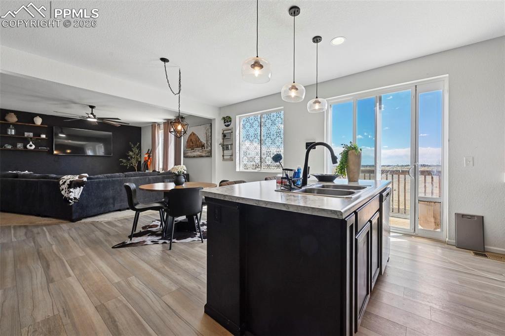 Image 6 of 43: Kitchen island featuring a double-basin sink and quartz countertop