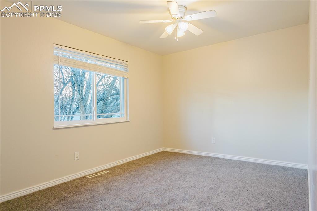 Image 11 of 20: Carpeted spare room with baseboards and a ceiling fan