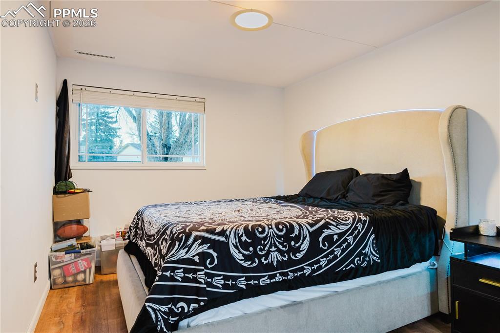 Image 15 of 20: Bedroom with wood finished floors