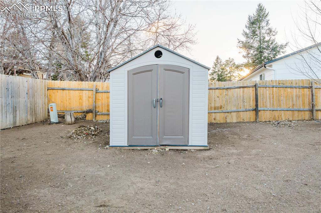 Image 3 of 20: View of shed with a fenced backyard