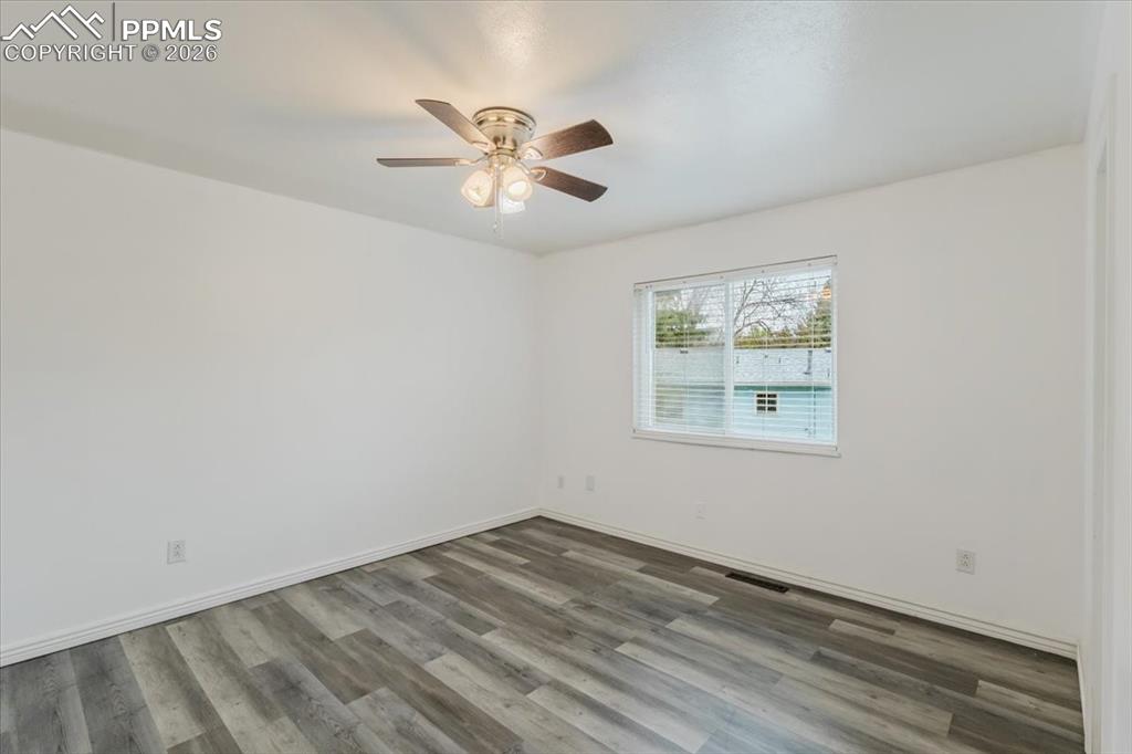Image 30 of 45: Interior space featuring wood-finish flooring, white walls, and a ceiling f