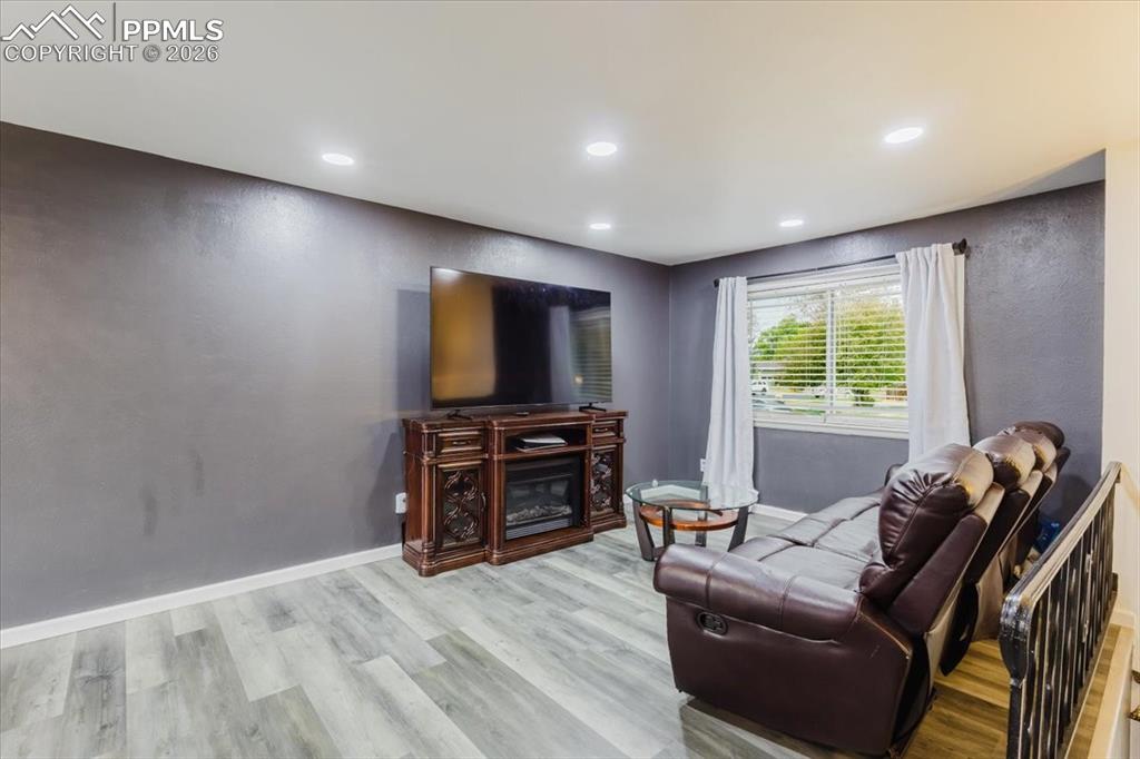 Image 37 of 45: Living area featuring light wood-finish flooring, recessed lighting, and a