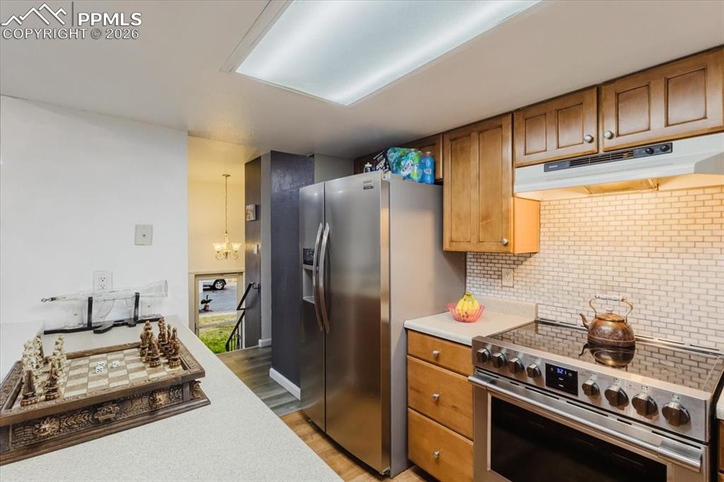 Image 43 of 45: Kitchen featuring stainless steel appliances, light wood-finish cabinetry,
