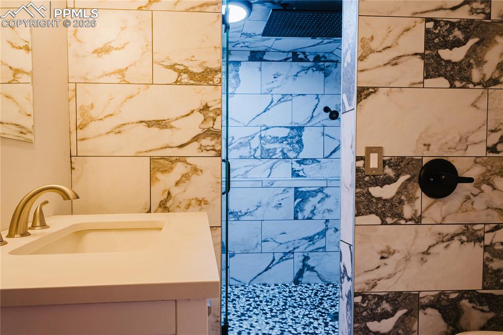 Image 6 of 20: Full bath with a tile shower and vanity