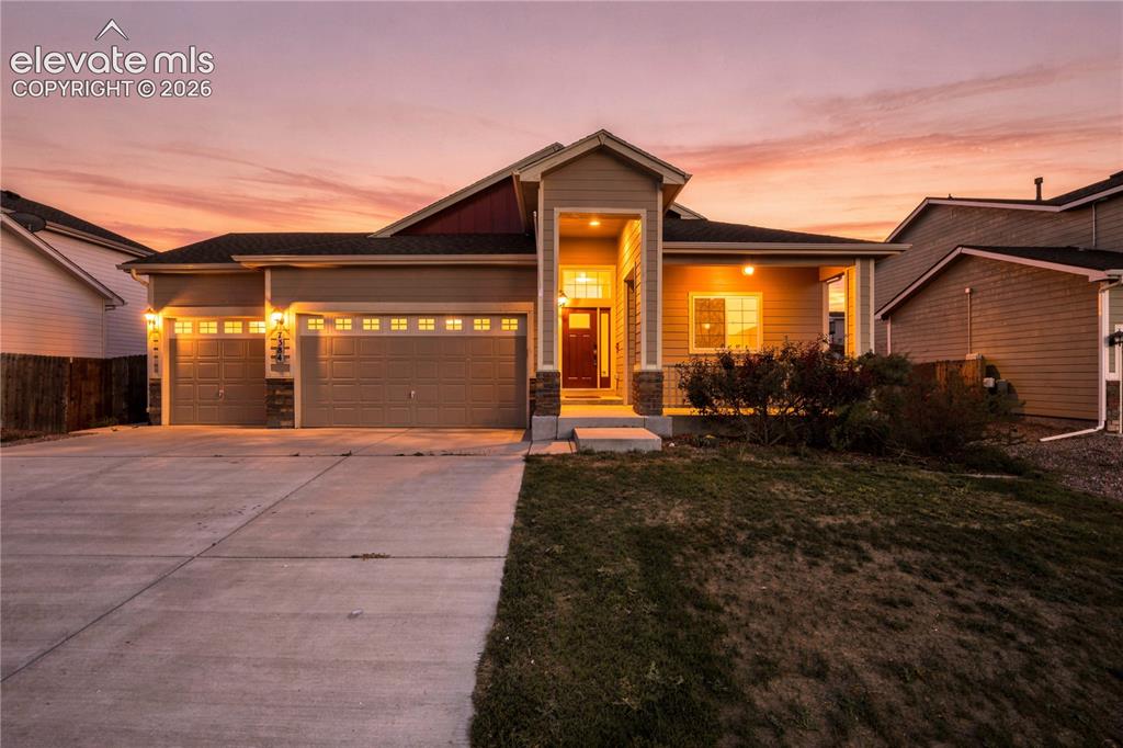 Caption: Contemporary single-story residence with an attached three-car garage, covered entry, and front porc