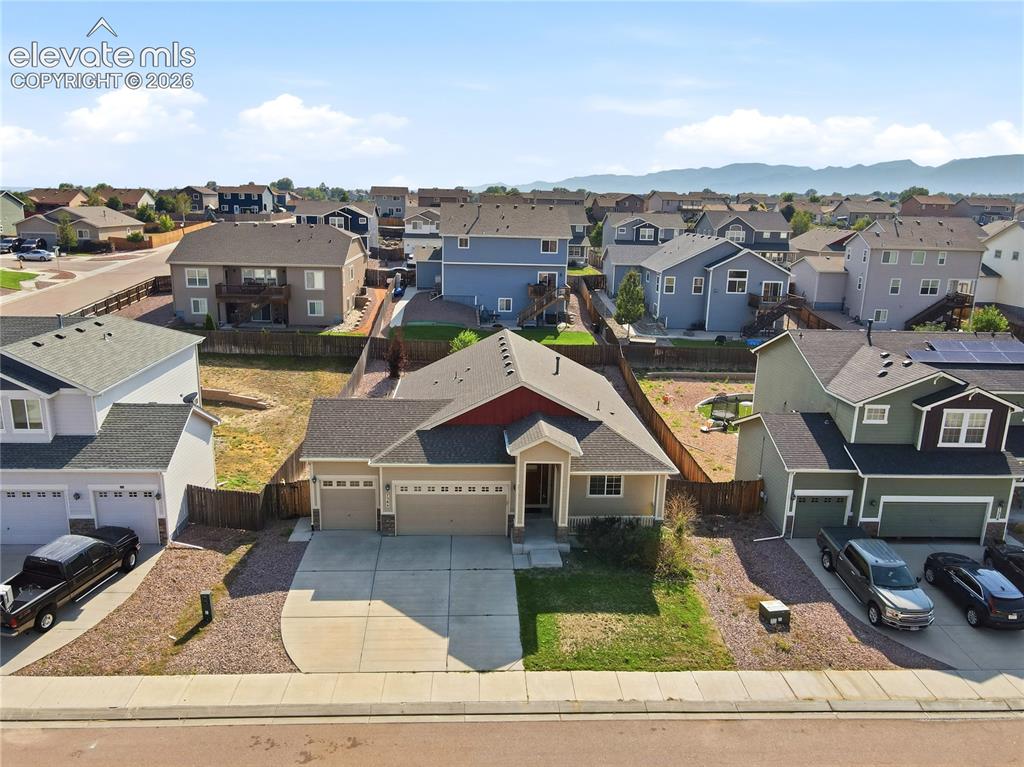 Image 3 of 46: Single-story exterior with a covered front porch featuring stone accents an