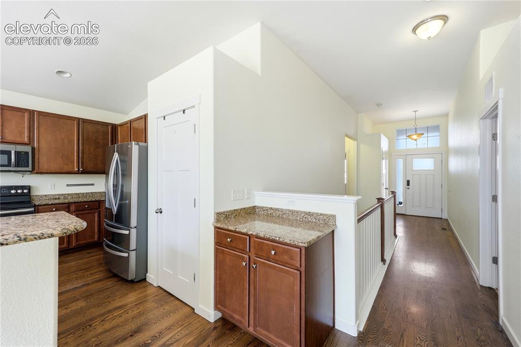 Image 5 of 46: Single-story residence featuring a two-car garage, concrete driveway, and a
