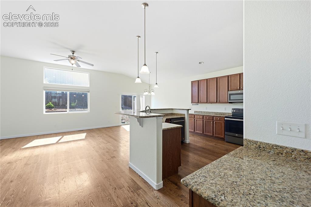 Image 6 of 46: Hallway featuring wood-finish flooring, white panel doors, and a wood and w