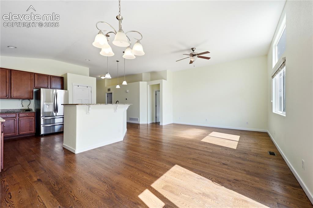 Image 9 of 46: Kitchen featuring a peninsula with a stainless steel sink, dark wood-finish