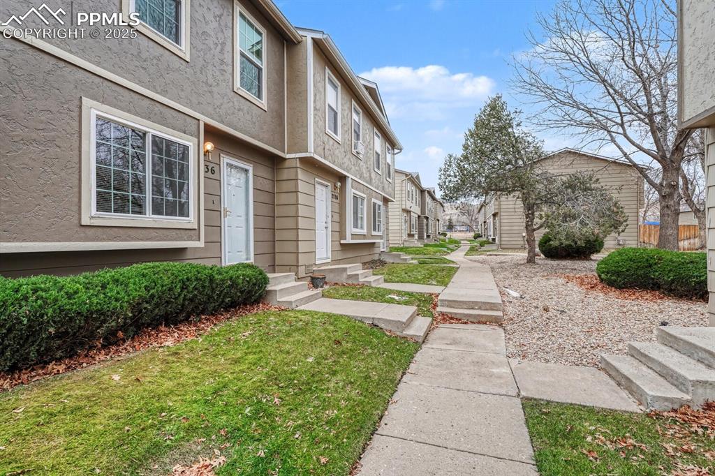 Image 4 of 32: Surrounding community with a residential view and a yard