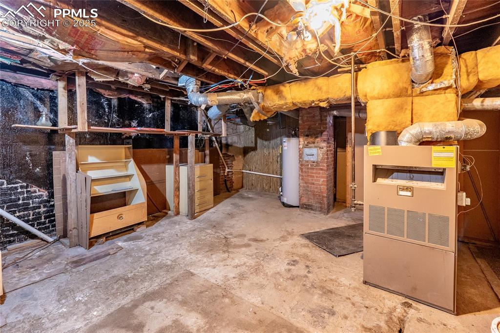Image 22 of 30: Unfinished basement with water heater