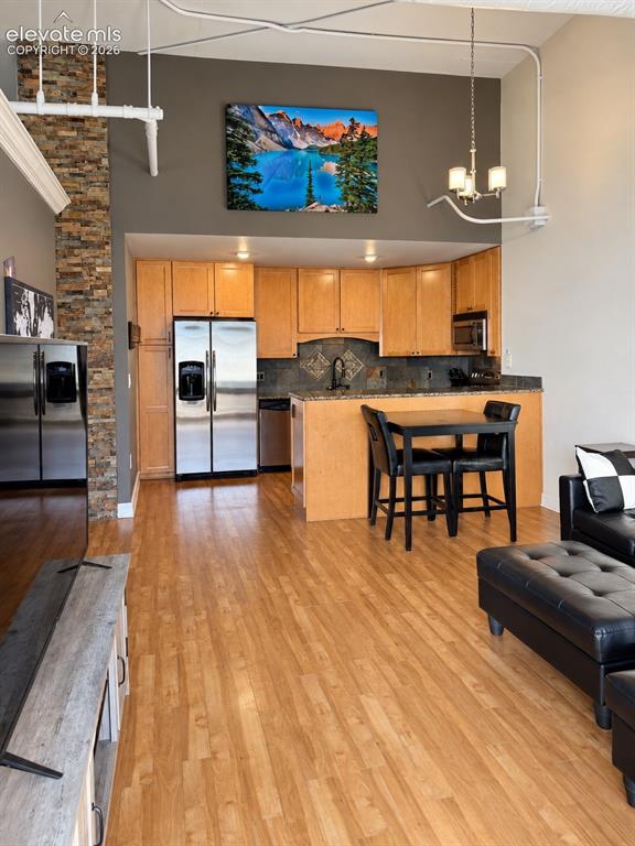 Image 10 of 35: Kitchen featuring wood-finish cabinetry, stainless steel appliances, and a 