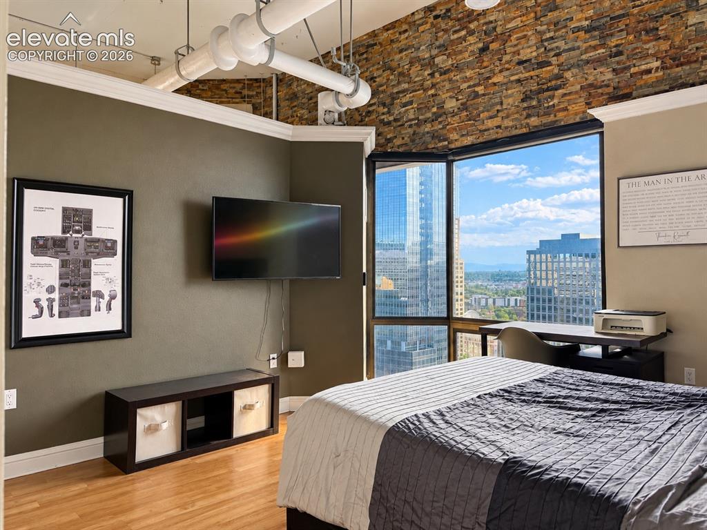 Image 18 of 35: Expansive corner window with city and distant mountain scenery