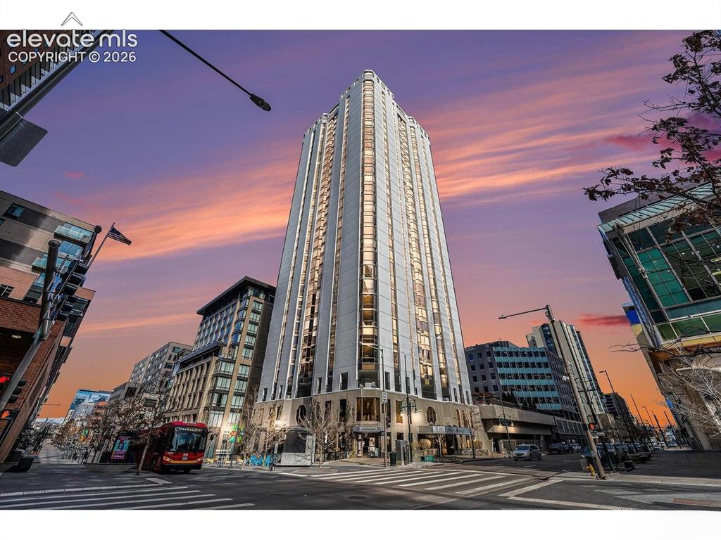 Image 22 of 35: Modern high-rise building with a distinctive architectural design, featurin