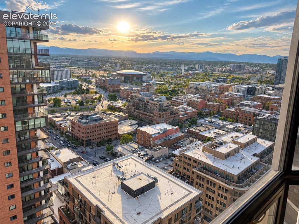 Image 3 of 35: Expansive city skyline with distant mountain ranges