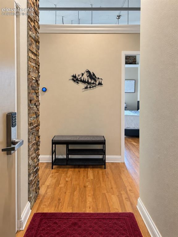 Image 5 of 35: Wood-finish flooring, accent wall with stacked stone, smart thermostat, dig