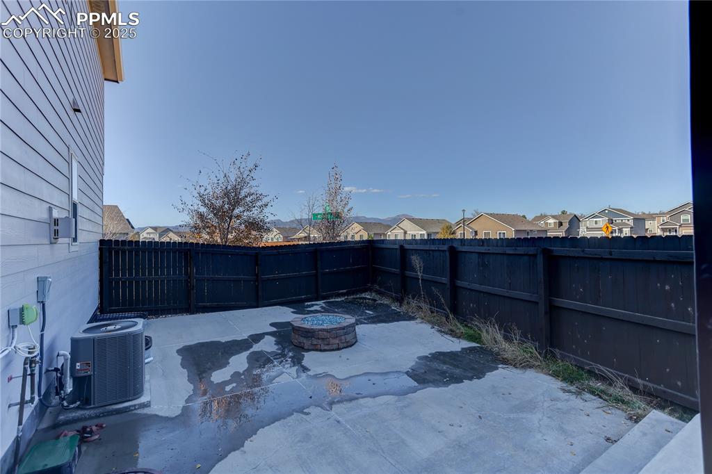 Image 25 of 26: Side patio with fire pit