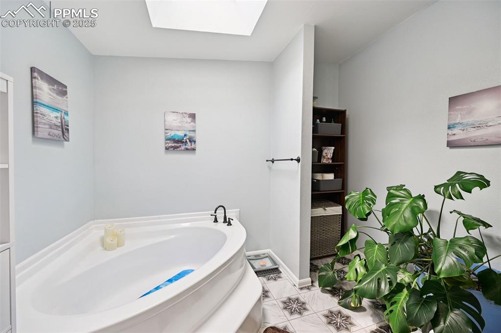 Image 23 of 48: Huge Soaking Tub and Skylight