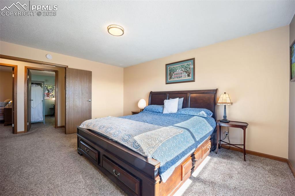 Image 13 of 47: Bedroom featuring light carpet