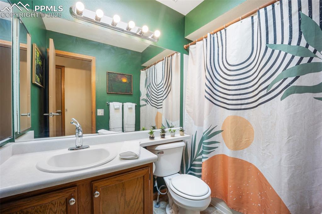 Image 19 of 47: Bathroom with a shower with curtain and vanity