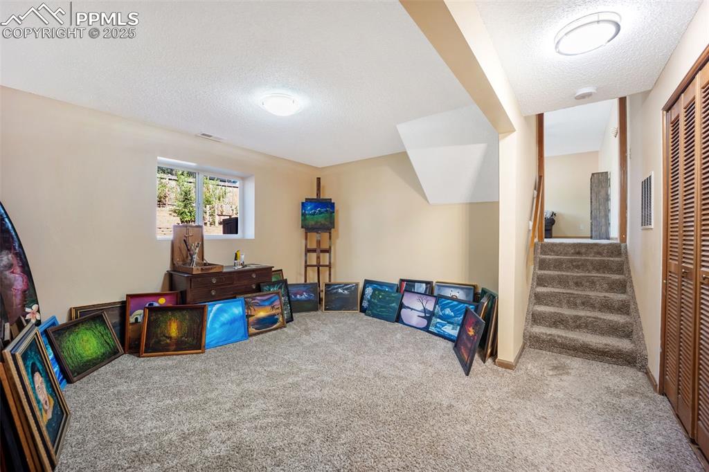 Image 25 of 47: Game room featuring carpet flooring and a textured ceiling