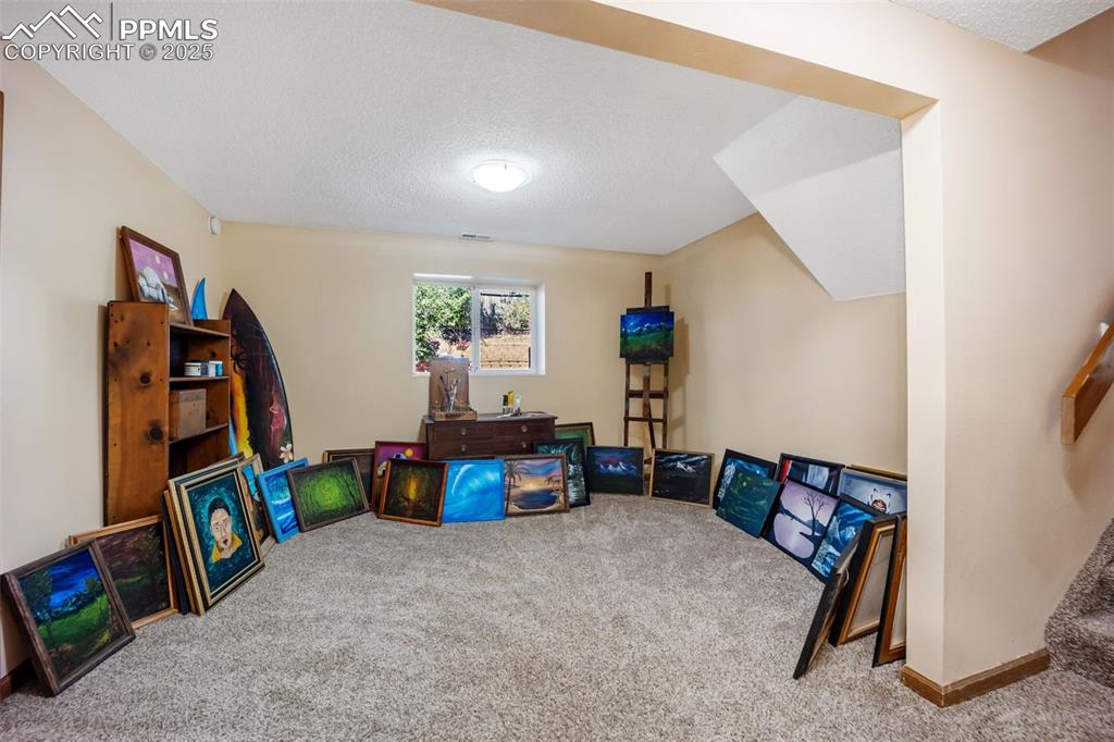 Image 27 of 47: Playroom featuring carpet and a textured ceiling