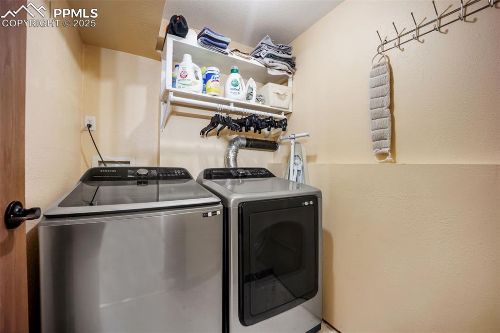 Image 33 of 47: Laundry room featuring independent washer and dryer