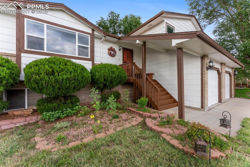 Image 5 of 47: View of front of home with a garage and stairs