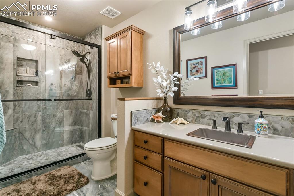 Image 39 of 50: Custom Basement Bath w/Heated Floors and Shower Seat