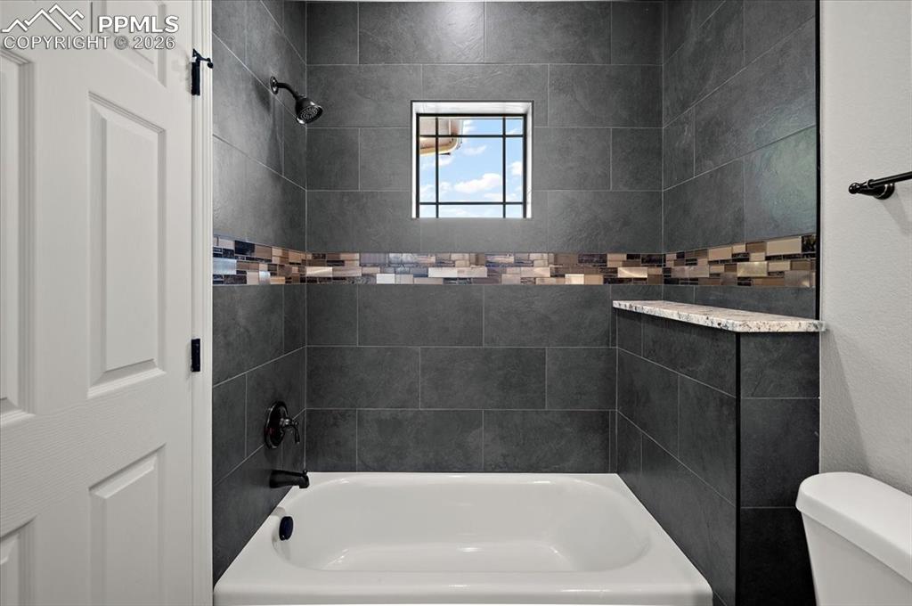 Image 17 of 40: Bathroom featuring shower / bath combination and toilet