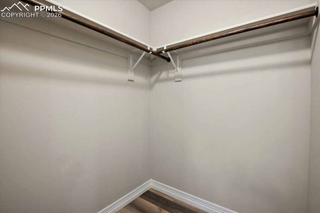 Image 21 of 40: Walk in closet featuring wood finished floors