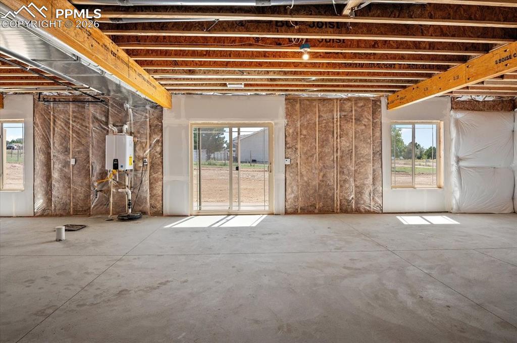 Image 27 of 40: Miscellaneous room with tankless water heater