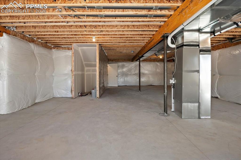 Image 28 of 40: Unfinished basement featuring heating unit