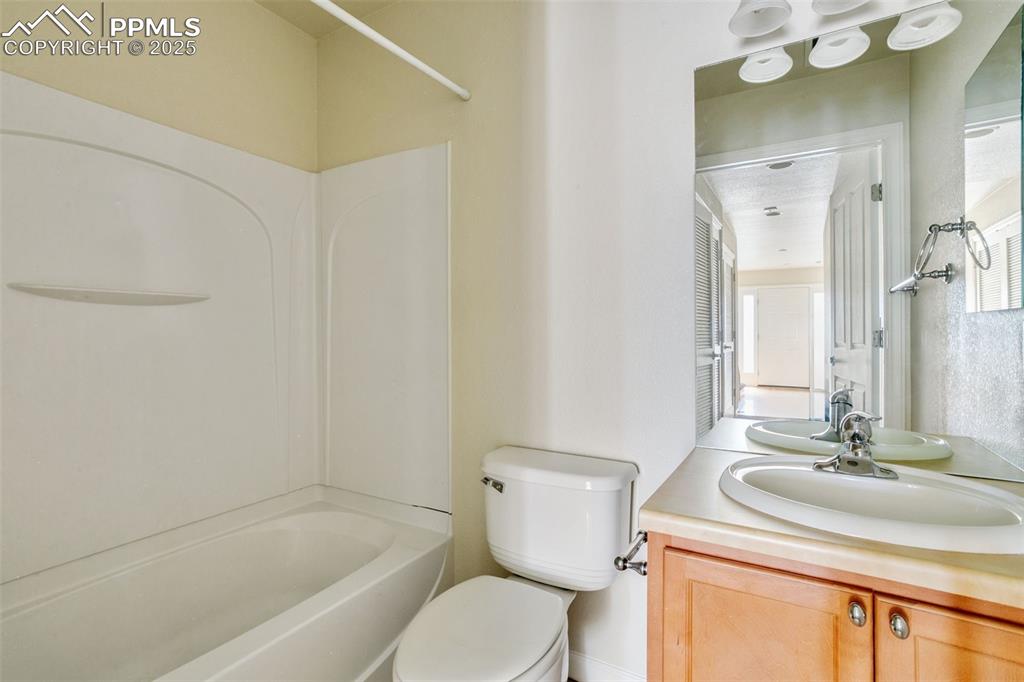 Image 26 of 28: Full bathroom featuring shower / bath combination and vanity