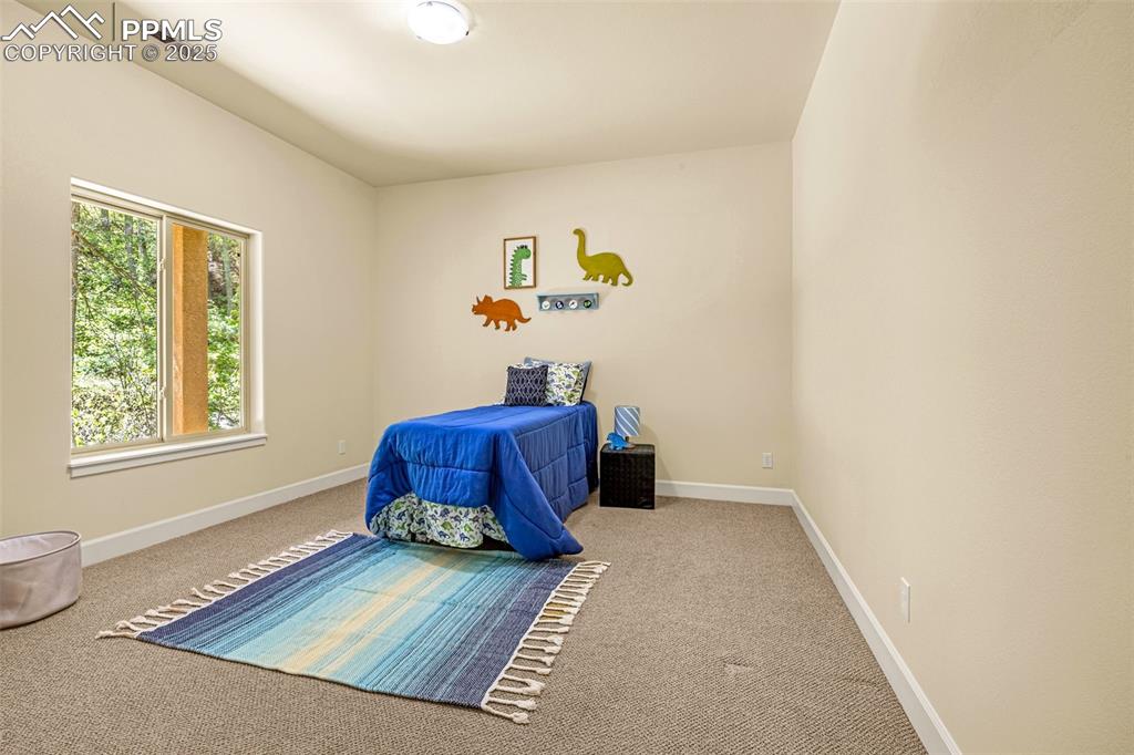 Image 25 of 41: Carpeted bedroom featuring baseboards