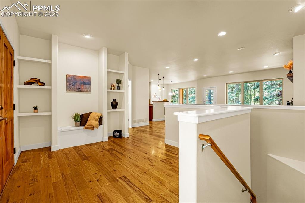 Image 3 of 41: Corridor with an upstairs landing, light wood finished floors, healthy amou
