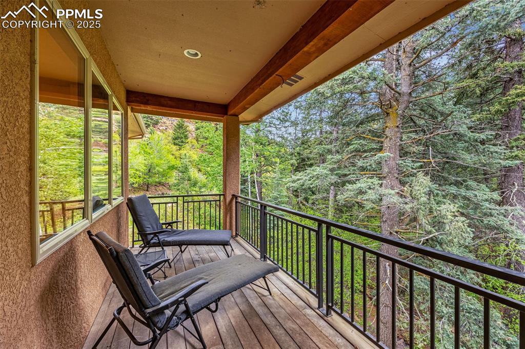 Image 31 of 41: Wooden deck featuring a forest view