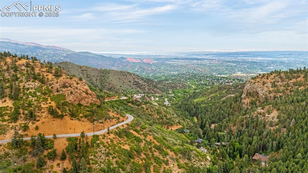 Image 37 of 41: View of mountain backdrop featuring a heavily wooded area