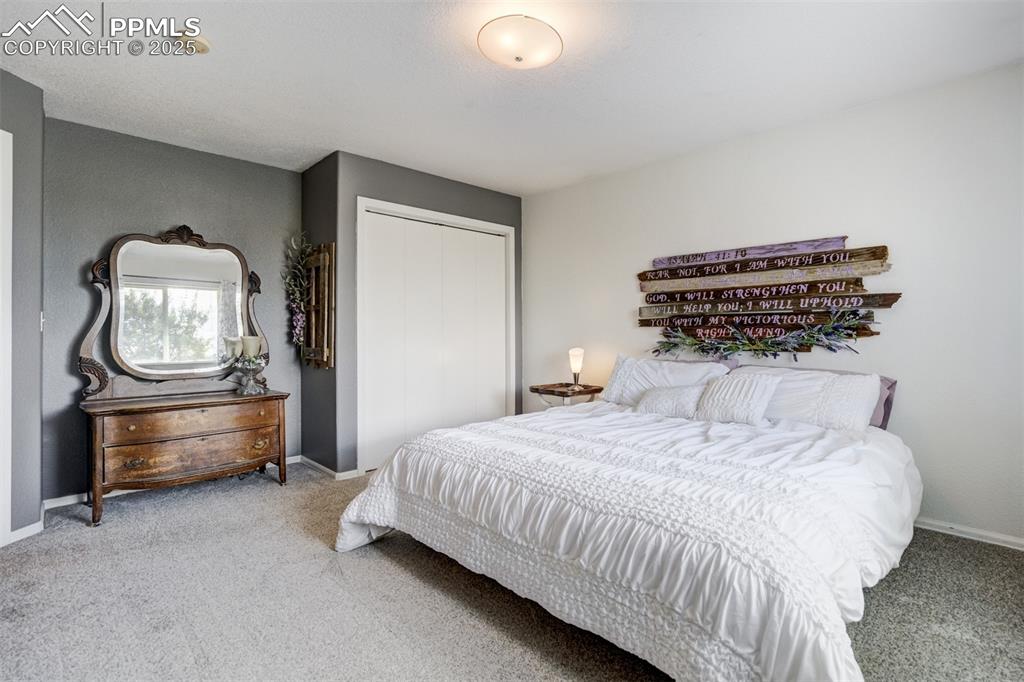 Image 16 of 50: Carpeted bedroom with baseboards and a closet