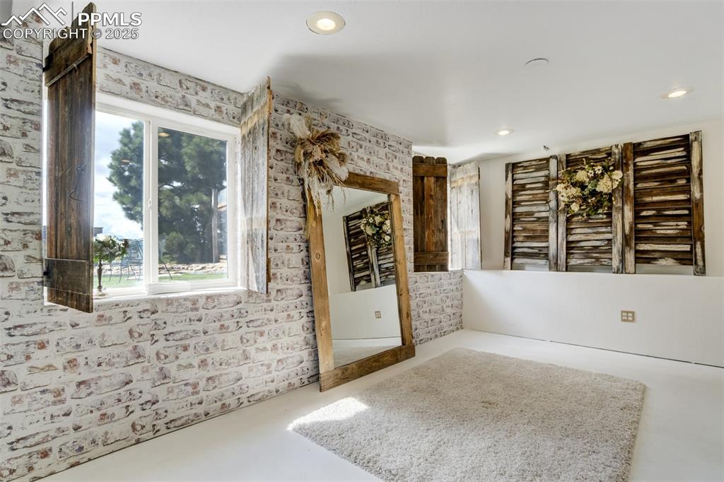 Image 20 of 50: Empty room featuring finished concrete flooring, healthy amount of natural