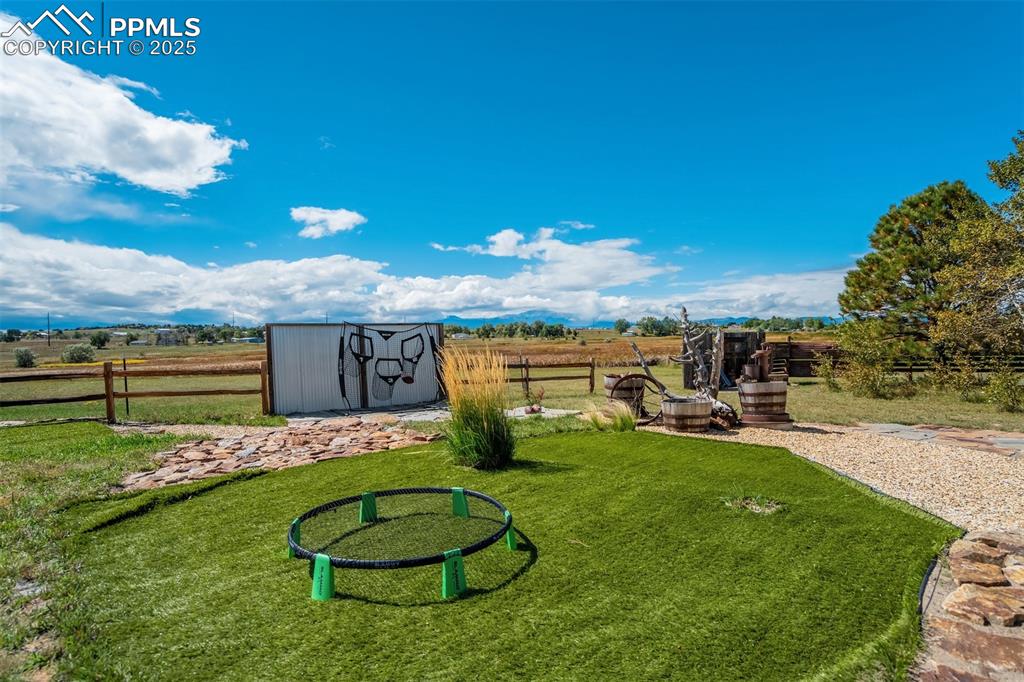 Image 37 of 50: View of yard featuring a storage shed and a rural view