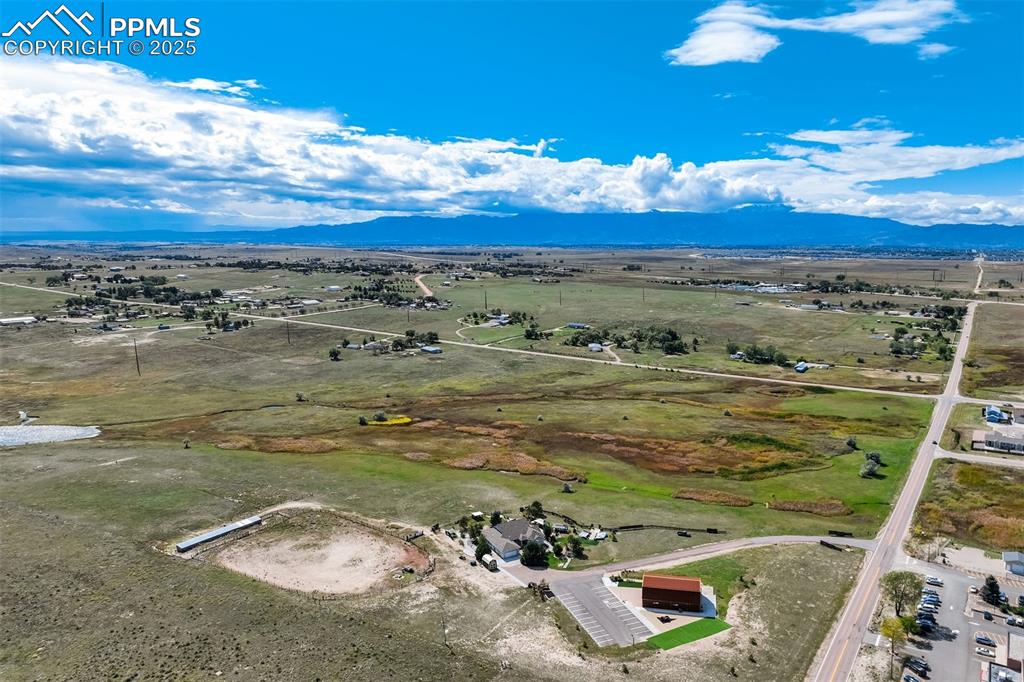 Image 4 of 50: Aerial view of sparsely populated area featuring mountains