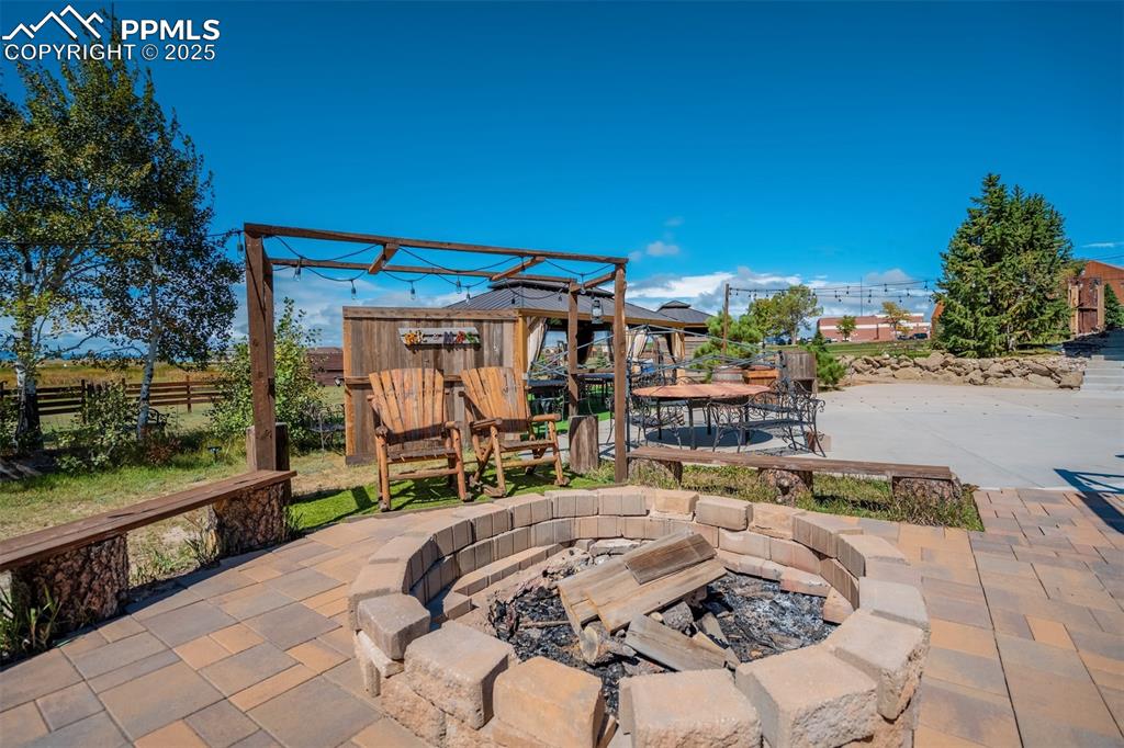 Image 40 of 50: View of patio / terrace with an outdoor fire pit
