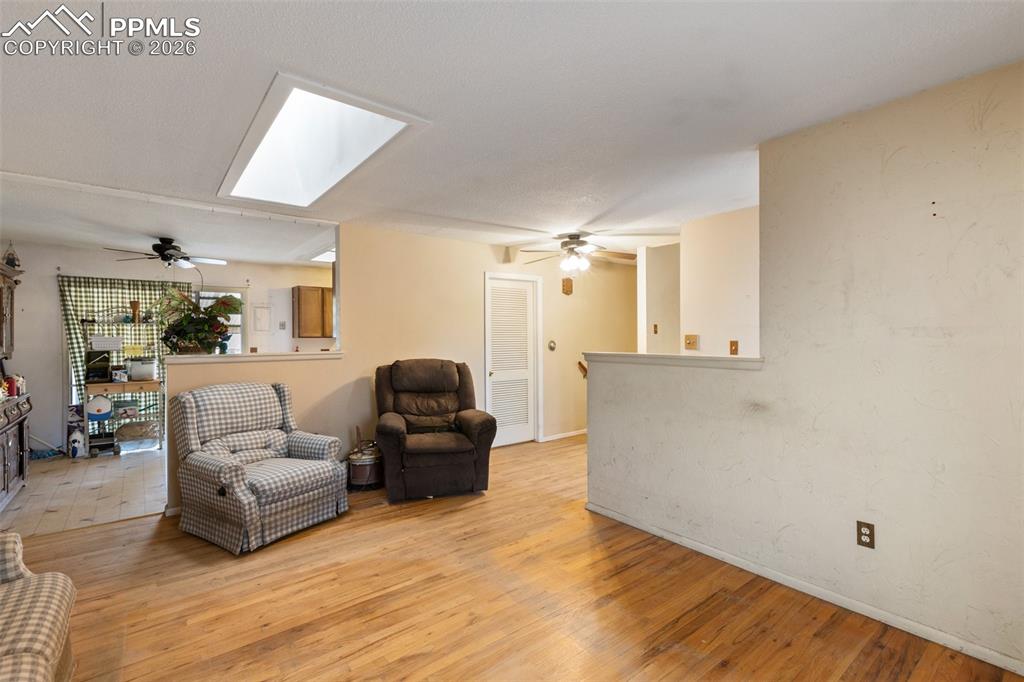 Image 12 of 34: Living room with skylight