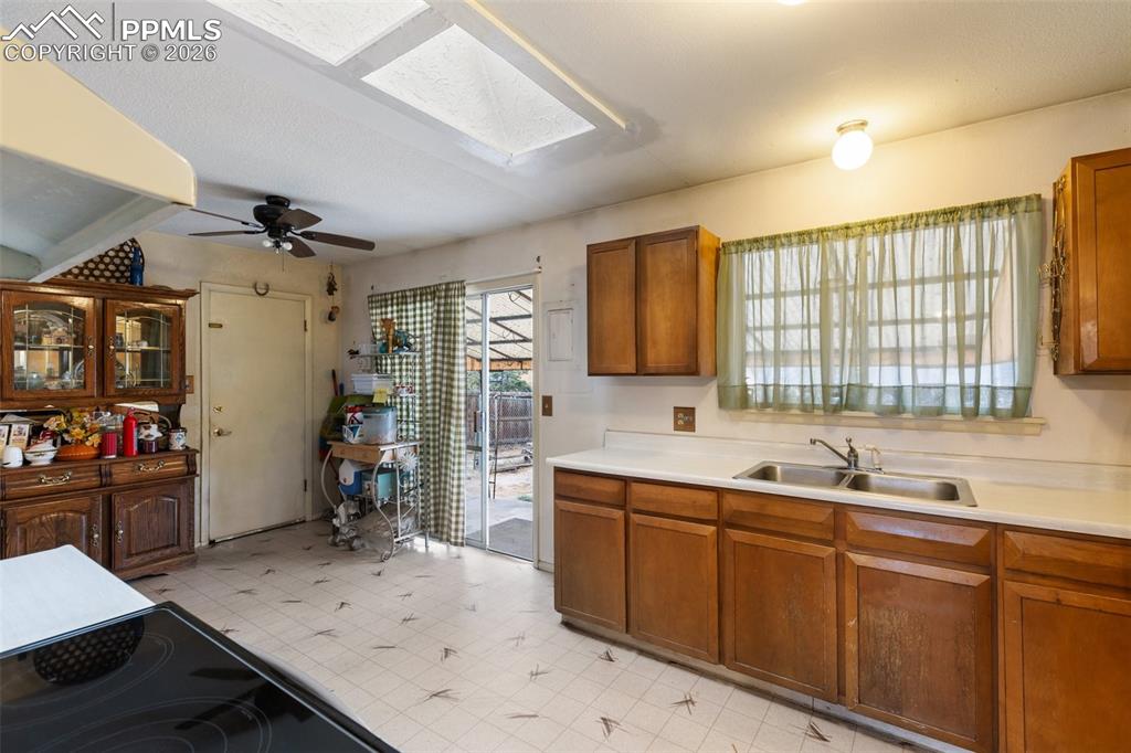 Image 13 of 34: Eat-in kitchen features a skylight and walks out to the covered patio