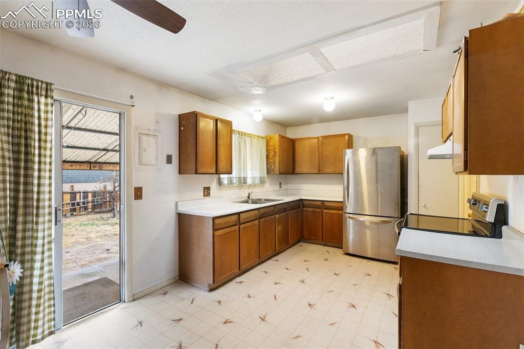 Image 14 of 34: Kitchen walks out to covered patio
