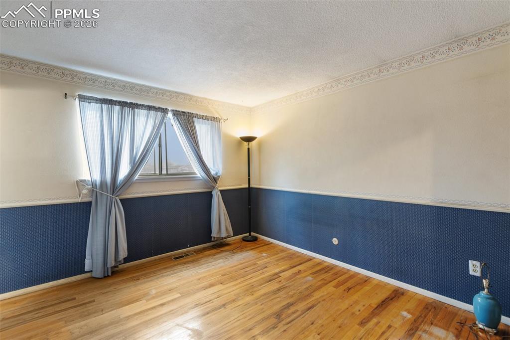 Image 20 of 34: Primary bedroom with wood flooring