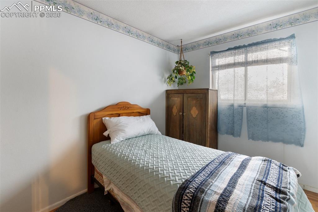 Image 24 of 34: One of 3 bedrooms on the upper level - features wood flooring